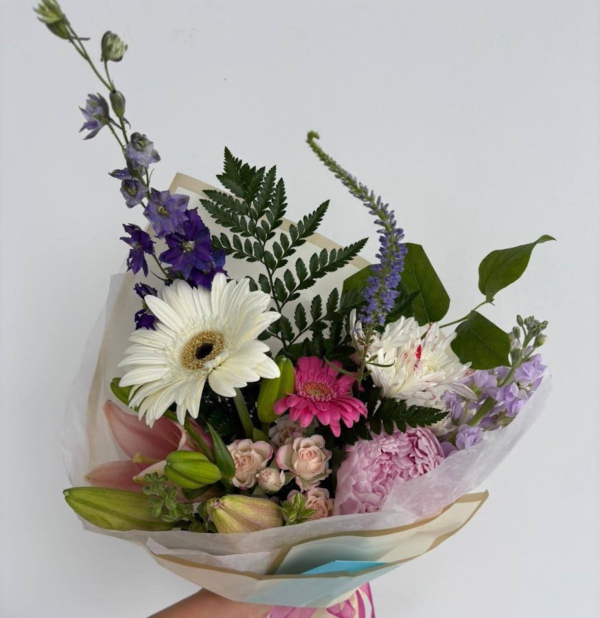Pastel wrapped bouquet with gerbera, roses, and lilies